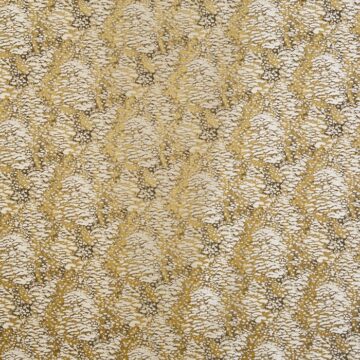 Mustár színű koptatott mintás textil fényes szálakkal díszítve
